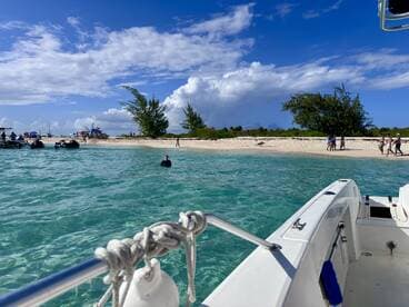 A vibrant scene at a sandbar with people enjoying the beach and swimming, while jet skis are anchored nearby — perfect for a fun day on the water.