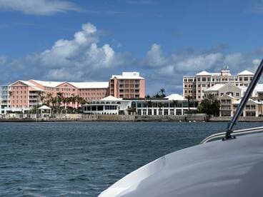 A picturesque view of colorful waterfront buildings from a boat, showcasing the vibrant architecture and serene harbor setting — perfect for capturing the essence of coastal adventures.