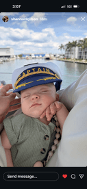 A cute baby wearing a captain's hat enjoys a day on the water, showcasing family fun and memorable moments aboard a boat.