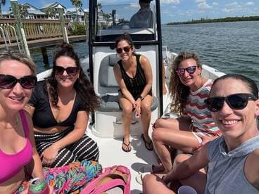 A group of friends enjoys a sunny day on the boat, capturing fun moments together — perfect for memorable outings and celebrations on the water.