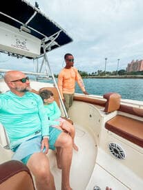 A family enjoys a day on the water aboard a fishing boat, capturing the essence of adventure and togetherness in a beautiful setting.
