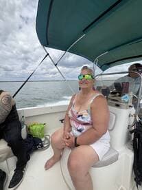 A woman enjoys a relaxing moment on a boat, showcasing the joy of a day out on the water.