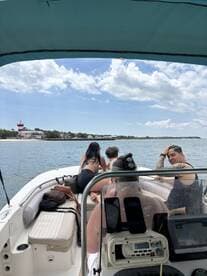 A group of friends enjoys a day on the water, taking in the scenic views from their boat. Perfect for summer outings and memorable adventures.