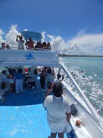 A lively group enjoys a fun day on the water, capturing moments aboard a boat as they splash through the waves — perfect for celebrations and memorable outings.