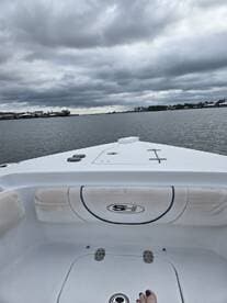 A view from the interior of a boat, showcasing the seating area and helm, perfect for a day on the water.