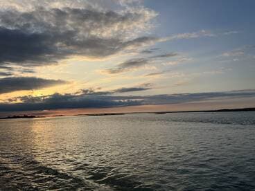 A serene view of the water and sky at sunset, capturing the tranquil beauty of nature.