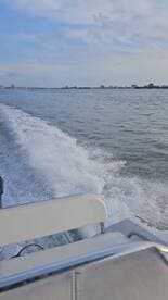 A dynamic view of a speedboat in motion, leaving a wake on the water, showcasing the thrill of boating adventures.