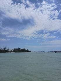 A scenic view of a waterway under a partly cloudy sky, capturing the serene atmosphere of a boating destination.
