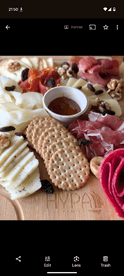 A beautifully arranged charcuterie platter featuring a variety of cheeses, meats, and accompaniments, perfect for onboard snacking during a boat trip.