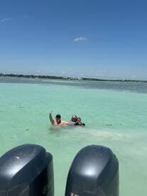 A joyful family enjoys a day of swimming and snorkeling in the crystal-clear waters, creating unforgettable memories under the sun.