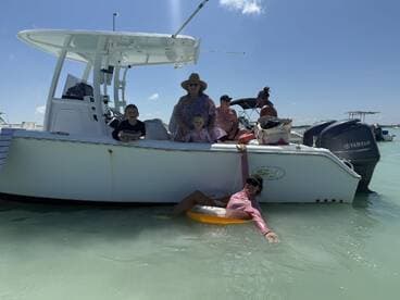 A joyful family enjoys a sunny day on the water, with kids playing and adults relaxing on a boat — perfect for memorable summer outings.