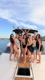 A lively group of friends celebrates on the deck of a yacht, enjoying a fun day on the water — perfect for parties and special occasions.