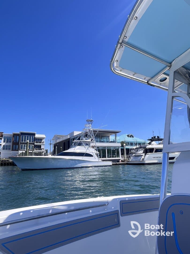 A clear view of a yacht docked at a marina, showcasing the sleek design and surrounding waterfront properties — perfect for luxury boating enthusiasts.