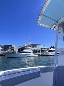 A clear view of a yacht docked at a marina, showcasing the sleek design and surrounding waterfront properties — perfect for luxury boating enthusiasts.