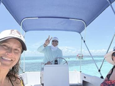A joyful moment captured on a boat with smiling guests enjoying a sunny day on the water — perfect for memorable tours and adventures.