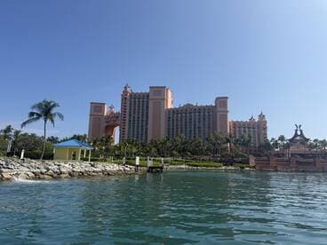 A picturesque view of the Atlantis Resort, showcasing its stunning architecture against a clear blue sky, perfect for travelers seeking luxury and adventure in the Bahamas.