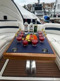 A vibrant display of cocktails and fresh fruit on a boat table, perfect for entertaining guests and enjoying a luxurious day on the water.