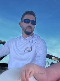 A man relaxes on a boat, showcasing a laid-back day on the water. Perfect for capturing the essence of boating adventures.