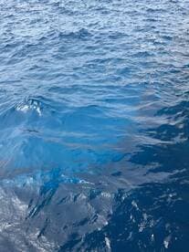 An unclear view of ocean waves, lacking identifiable features or subjects.