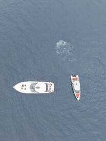 Aerial view of two boats on the water, showcasing a vibrant boating experience — perfect for adventure seekers and water enthusiasts.
