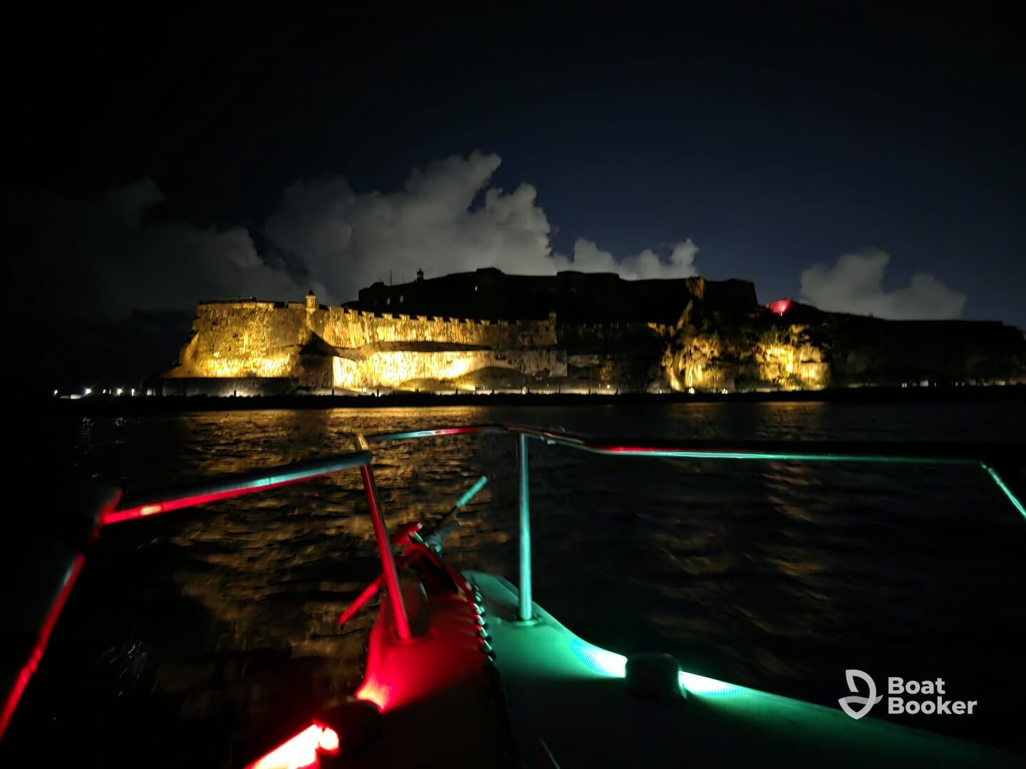 A stunning night view of a historic landmark illuminated against the dark sky, captured from a boat, showcasing the beauty of evening boat tours.