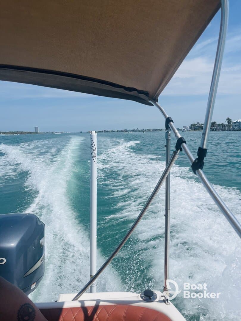 A dynamic view from the helm of a speedboat cruising through turquoise waters, showcasing the thrill of boating adventures.