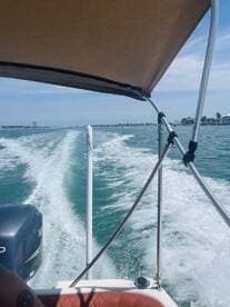 A dynamic view from the helm of a speedboat cruising through turquoise waters, showcasing the thrill of boating adventures.