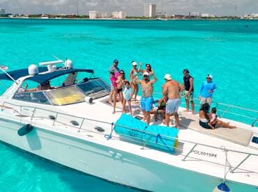 A lively group enjoys a fun day on a yacht, celebrating under the sun with turquoise waters as the backdrop — perfect for unforgettable summer adventures.