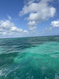 A scenic view of turquoise waters and clouds, capturing the essence of a tranquil ocean environment.