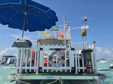 A vibrant floating bar setup featuring colorful decorations and amenities, perfect for enjoying drinks and relaxation on the water.