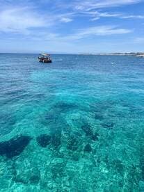 A vibrant view of a boat navigating through crystal-clear waters, showcasing the stunning marine environment perfect for exploration and adventure.