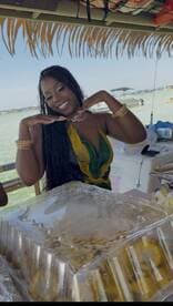 A vibrant scene featuring a smiling woman showcasing delicious food on a boat, perfect for catering and onboard dining experiences.