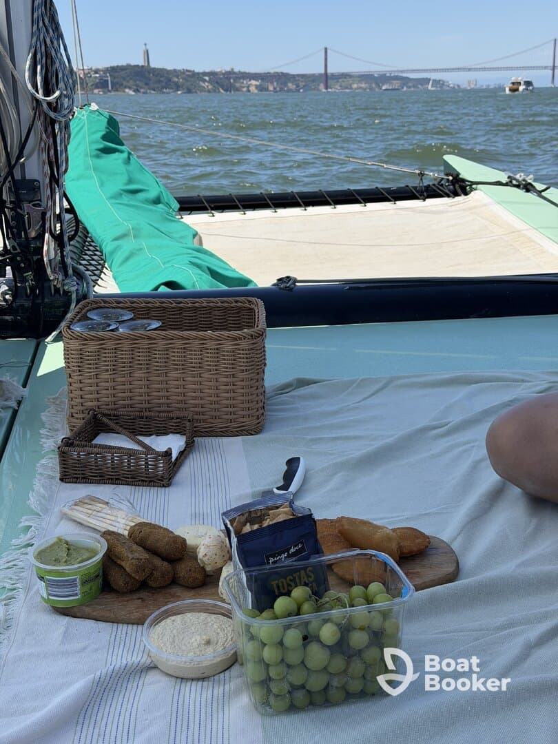 A delightful spread of snacks including grapes, hummus, and other treats laid out on a boat, perfect for enjoying a relaxing day on the water.