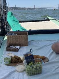 A delightful spread of snacks including grapes, hummus, and other treats laid out on a boat, perfect for enjoying a relaxing day on the water.