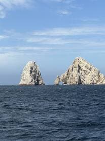 Stunning view of the iconic rock formations at Cabo San Lucas, a must-see landmark for boat tours and scenic cruises in the region.