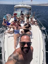A lively group enjoys a fun day on the water, celebrating with drinks and laughter aboard a boat — perfect for summer outings and memorable gatherings.