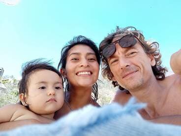 A joyful family selfie at the beach, capturing a moment of happiness and togetherness under the sun.