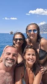A joyful group of friends poses for a selfie while enjoying a sunny day on the water, capturing the essence of fun and friendship during their boating adventure.