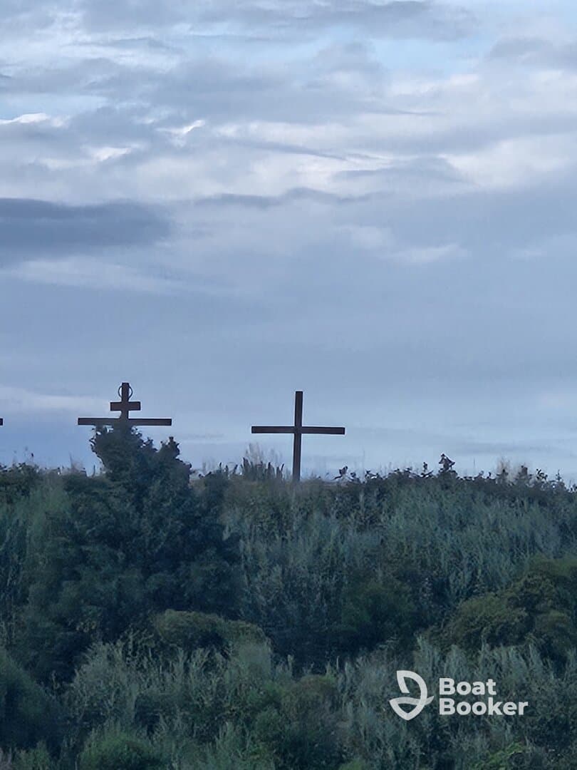 An unclear image featuring crosses against a cloudy sky, lacking identifiable details or context.