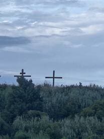 An unclear image featuring crosses against a cloudy sky, lacking identifiable details or context.