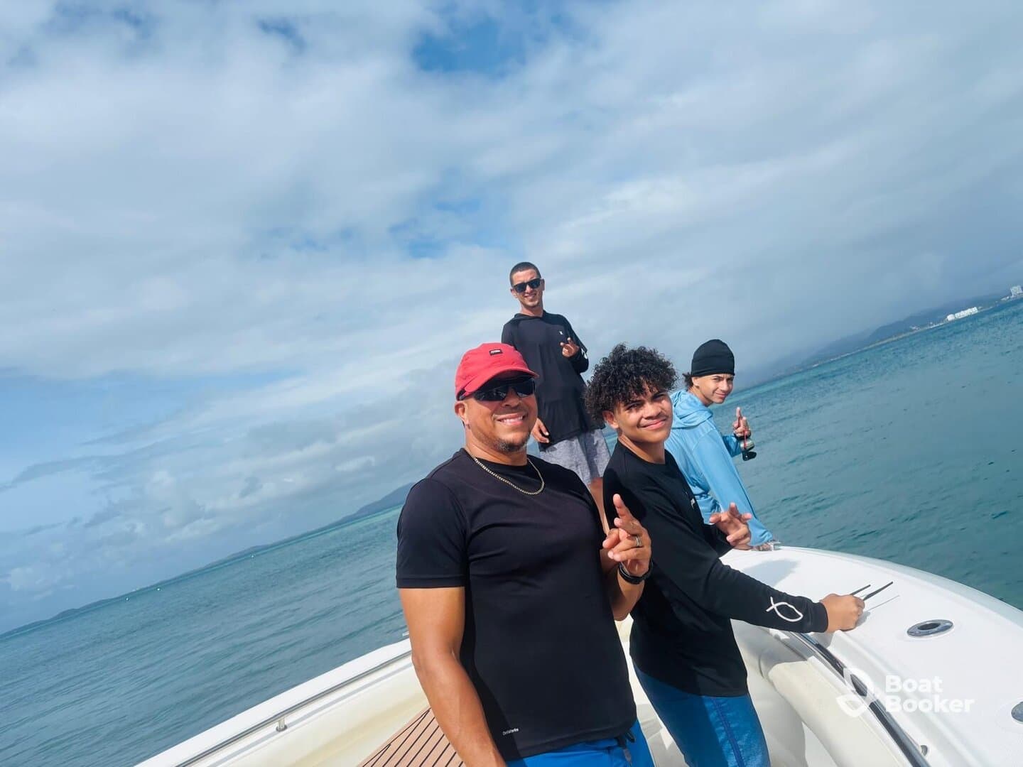 A group of friends enjoys a day on the water, posing on the boat while fishing — perfect for creating unforgettable memories on a fishing trip.