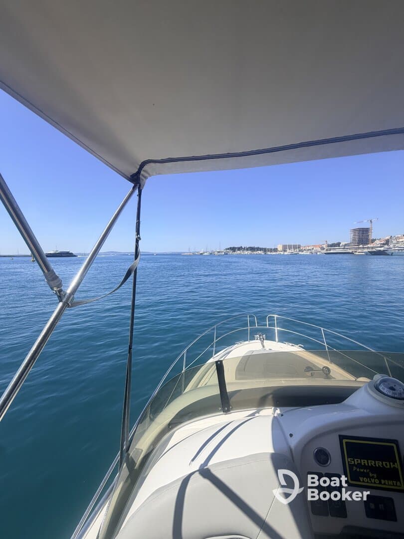 A clear view from the helm of a boat, showcasing the vessel's sleek design as it navigates calm waters, perfect for a day of exploration.