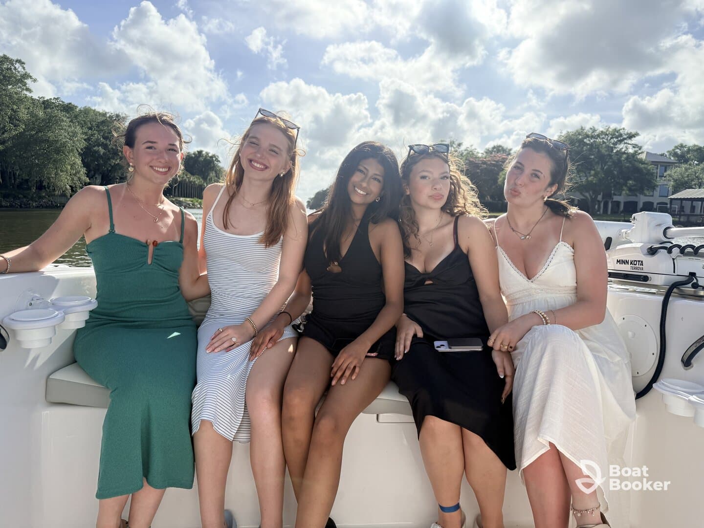 A group of friends enjoys a sunny day on a boat, capturing joyful moments together — perfect for celebrations and memorable outings on the water.