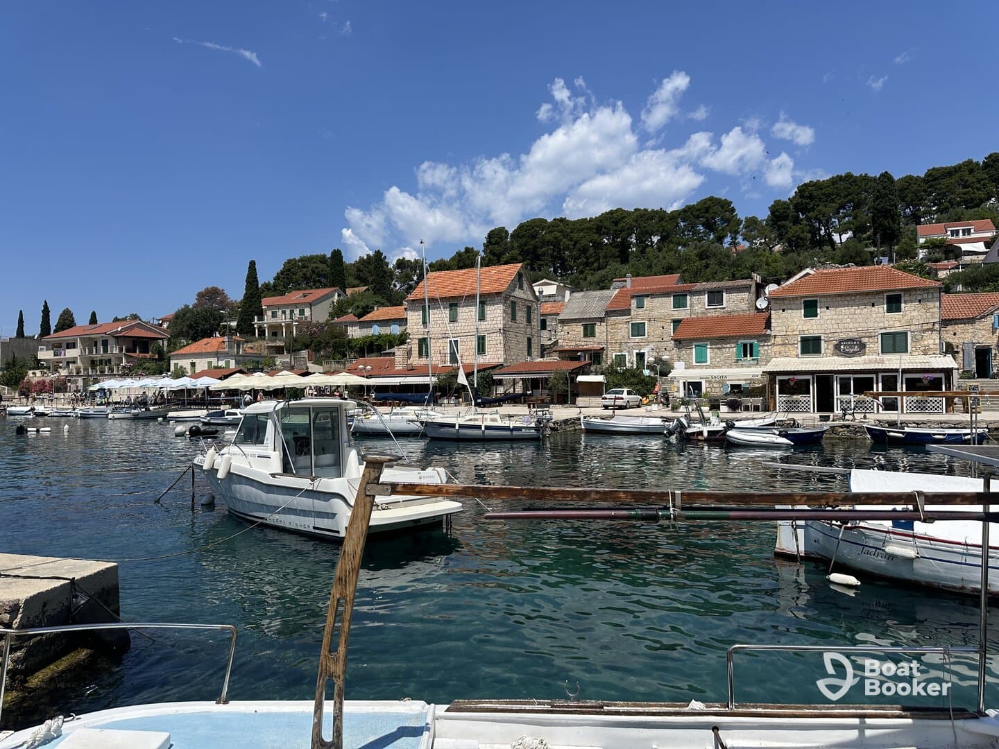 A picturesque view of a charming harbor filled with various boats and scenic waterfront buildings, perfect for exploring coastal destinations.