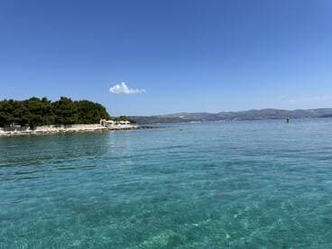 A stunning view of a serene coastline with crystal-clear waters, perfect for enjoying a day of relaxation and exploration on the water.