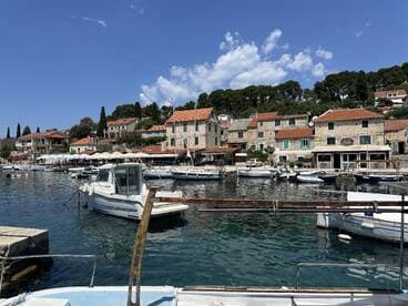 A picturesque view of a charming harbor filled with various boats and scenic waterfront buildings, perfect for exploring coastal destinations.