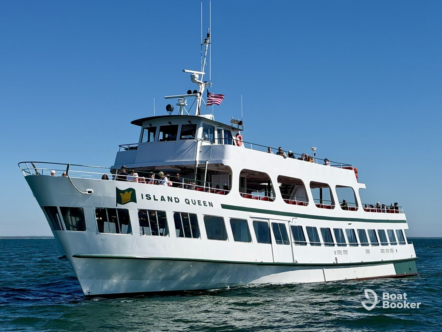 The Island Queen ferry cruises through clear waters, with guests enjoying the scenic views from the deck — a perfect choice for sightseeing adventures.