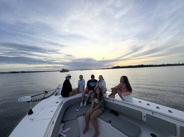 A group of friends enjoys a beautiful sunset on a boat, creating lasting memories on the water — perfect for gatherings and celebrations.