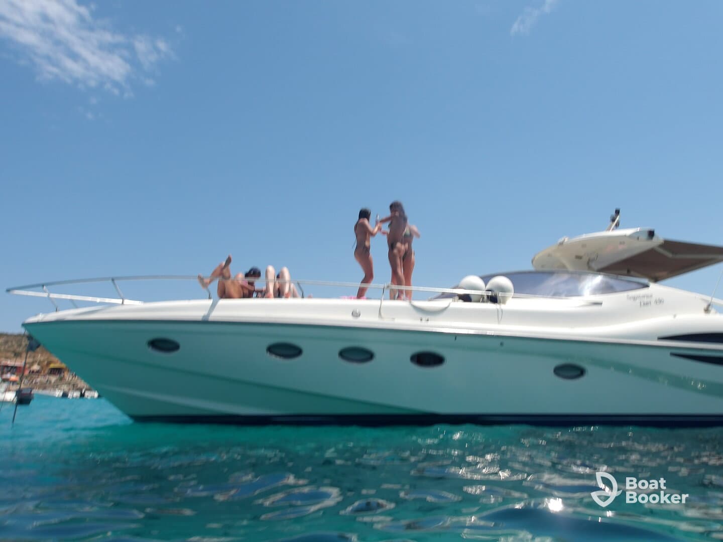 A lively group enjoys a sunny day on a boat, showcasing fun and relaxation in the water — perfect for summer outings and celebrations.