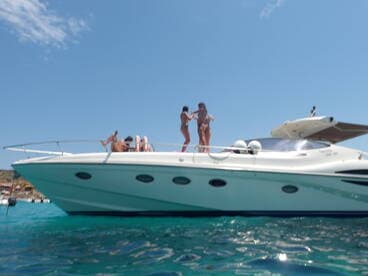 A lively group enjoys a sunny day on a boat, showcasing fun and relaxation in the water — perfect for summer outings and celebrations.